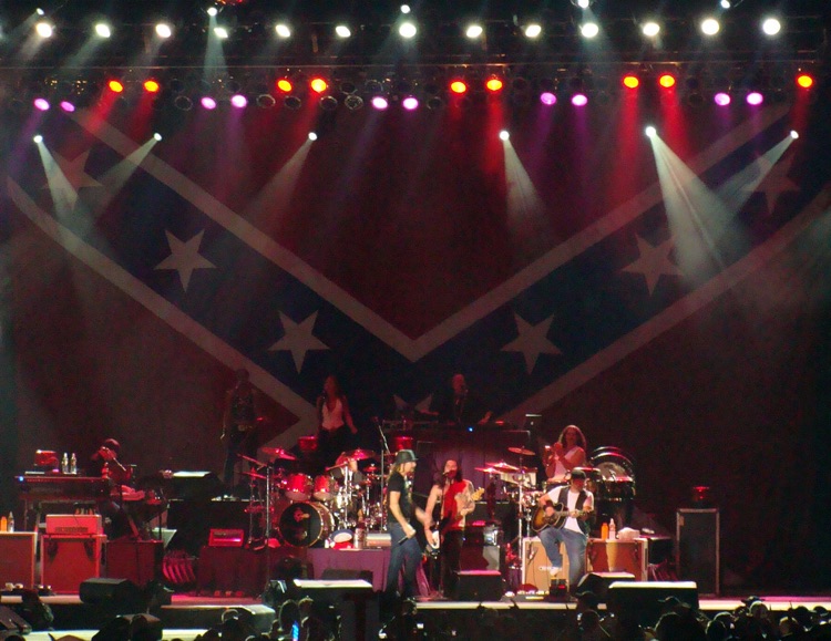 Kid Rock performs in front of a massive Confederate flag, 2009