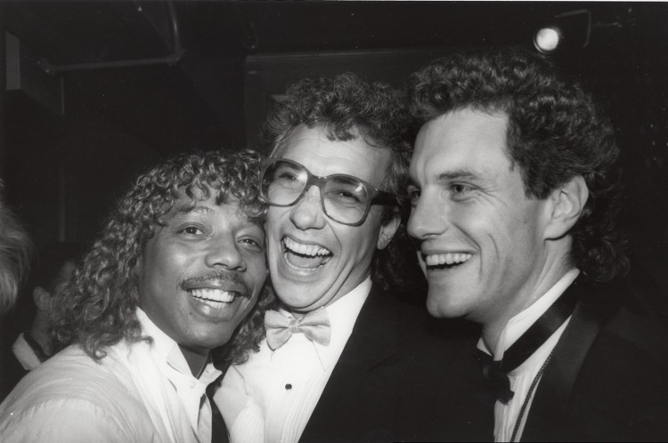 MTV co-founder Les Garland (c) laughs with Rick James and exec John Sykes