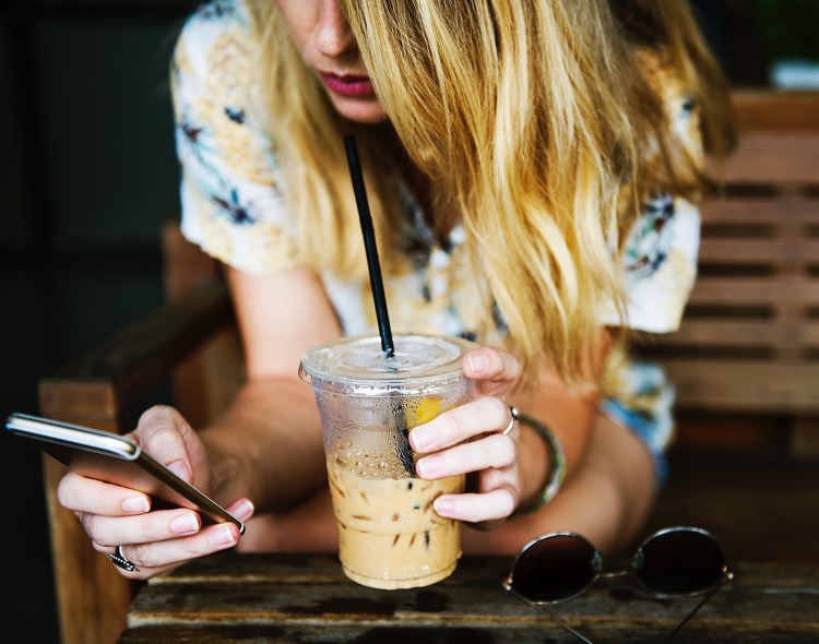 Attractive woman using Shazam in a bar