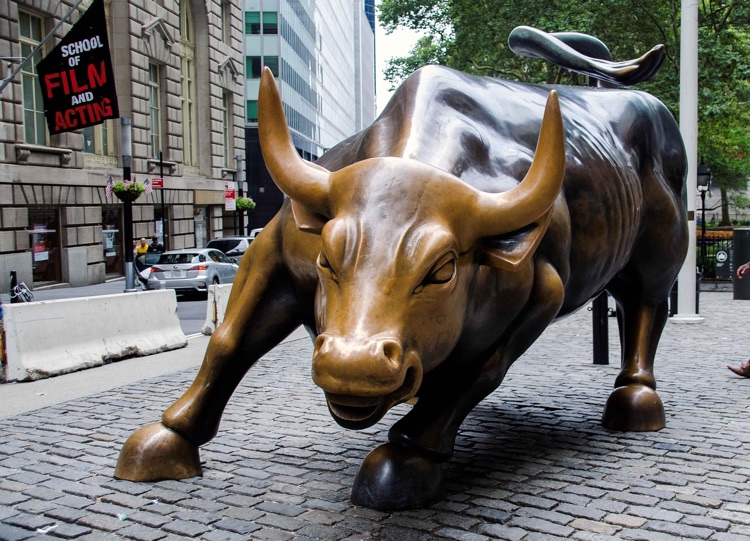 Spotify hits Wall Street (bull statue pictured)