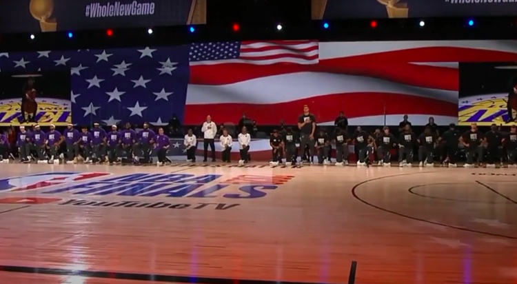 Cellist Ben Hong of the LA Philharmonic plays the National Anthem to start Game 1 of the NBA Finals between the Los Angeles Lakers and Miami Heat. Most players kneeled.