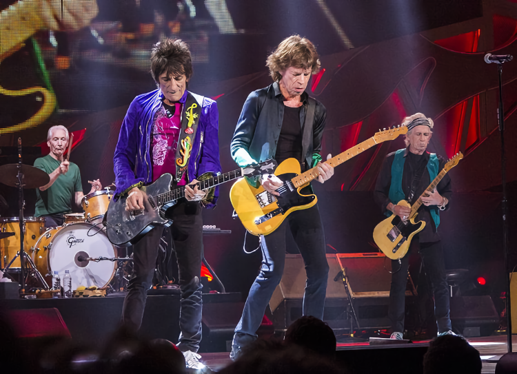 How old are the The Rolling Stones? Ronnie Wood is 74, Mick Jagger is 78, and Keith Richards is 77. Charlie Watts (on the drums) passed away at 80.